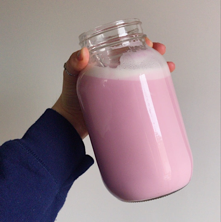 large mason jar filled with a rosy pink nut milk that has beet and rose added to it and the medicinal mushroom cordyceps