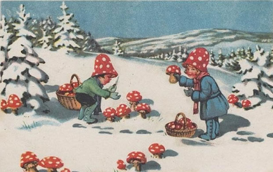 a vintage postcard shows two young children outside in the snow picking bright red mushrooms with white spots on them and putting them in baskets. They wear matching red with white polkadot hats and are surrounded by evergreen trees laden with snow.